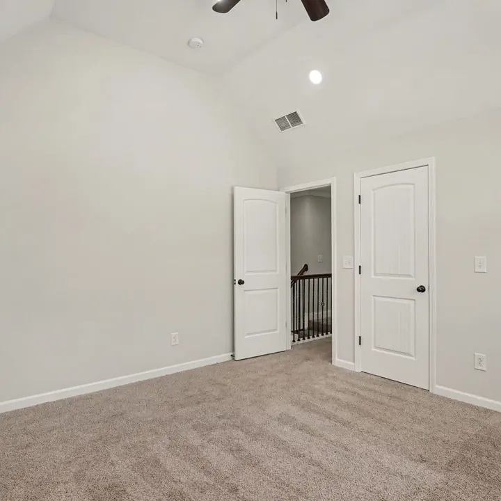 Bright bedroom with two windows and fresh carpet